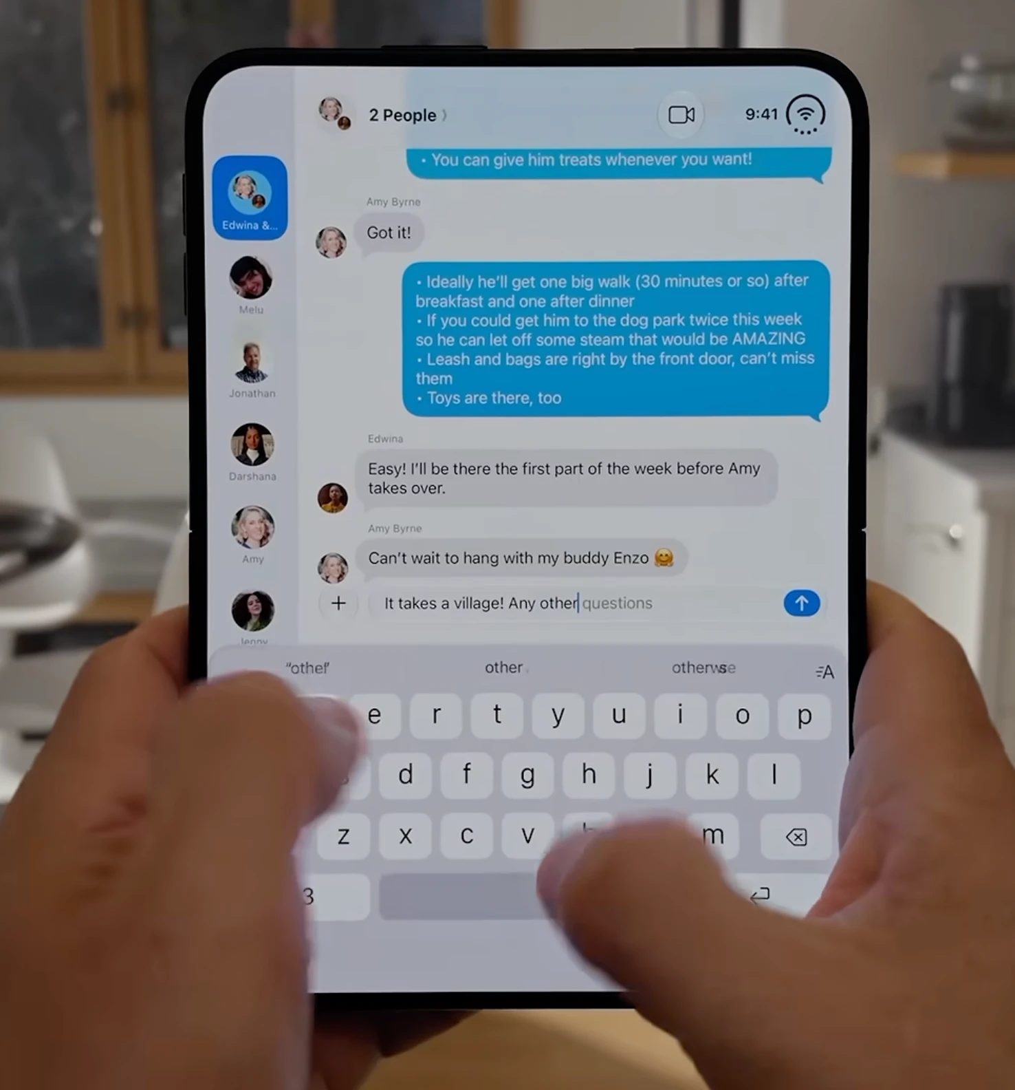 An iPhone Duo held in two hands, typing a reply with it folded; the keypad has three rows of letters and a fourth for 123, space and return.